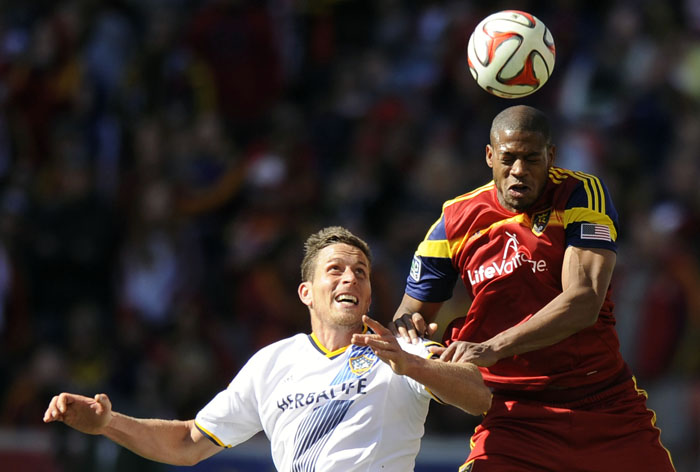 Real Salt Lake defender Chris Schuler (28) heads the ball over Los Angeles Galaxy forward Rob Friend (16) during a game at Rio Tinto Stadium on Saturday, March 22, 2014.