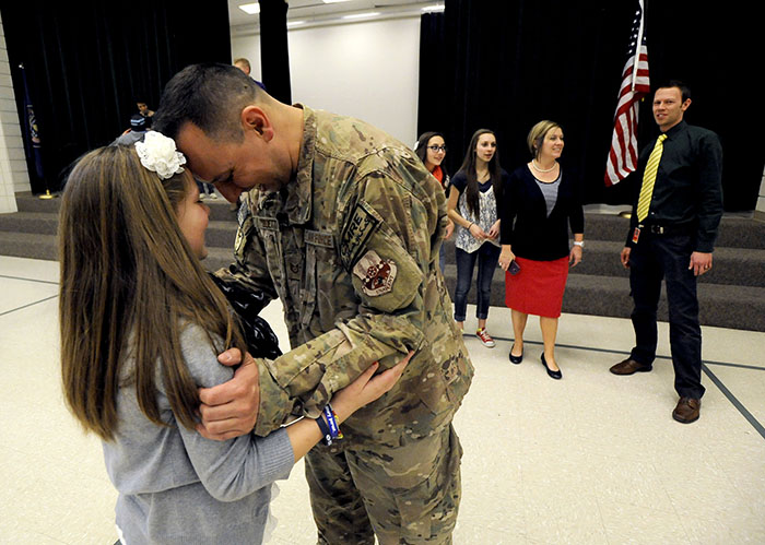 USAF TSgt Edward Goettig shares a moment with his 11-year-old daughter Addie after surprising her at Fox Hollow Elementary School on Thursday, March 6, 2014. Goettig had been deployed to Afghanistan since Aug. 27, 2013.