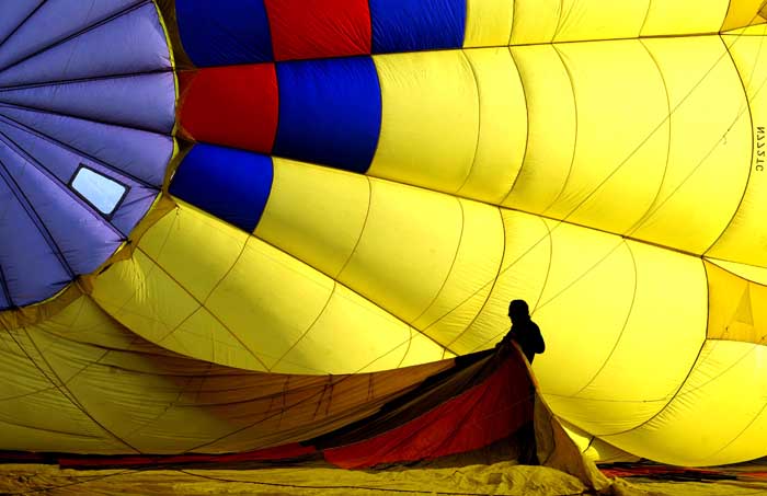 A helper stretches out part of a balloon as it is inflated during the media day launch on Thursday, May8, 2014 to prepare for the 40th Annual Walla Walla Balloon Stampede that runs this Friday through Sunday at Garrison Middle School in Walla Walla.