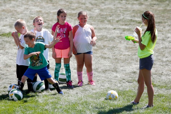 Richland High School sophomore-to-be Rachel Wolski sprays some of the kids with water to help they stay cool as they took part in the Bomber Soccer Academy on Tuesday morning at Bomber Field. Participants of the academy work with members of both of Richland High's soccer teams. On Friday, the last day of the camp, the kids will scrimmage the instructors. On July 18 and 19 is the Bomber Classic featuring 20 teams, 12 girls and 8 boys teams, competing in the soccer tournament at Bomber Field featuring schools from Idaho and Oregon with the championship games scheduled for 6 and 7:30 on the 19th.
