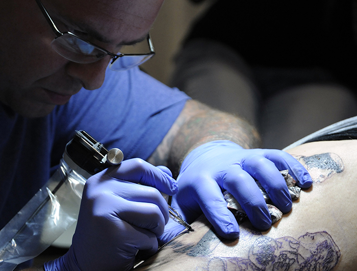 Hundreds make their way through the Meadowlands Expo Center in Secaucus checking out the vendors at 'Inked Out New Jersey' as some get tattoos, piercings, listen to live music, buy clothes and accessories, check out automobiles on display or just meet-and-greet with local tattoo artists on Friday, Sept. 12, 2014.Matt Gade | The Jersey Journal