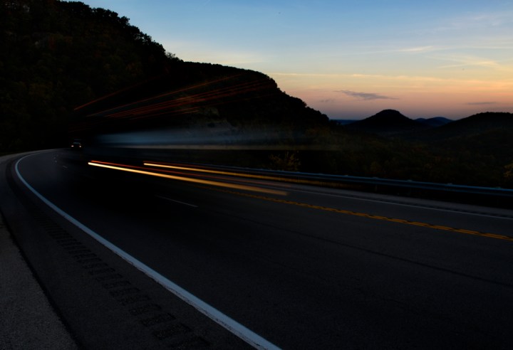 Trucks make their way through the mountains along Highway 421 early in the morning.