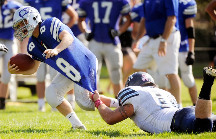 Bridgewater-Emery/Ethan's Jesse Grosdidier (8) fights for yardage as he is tackled by Hanson's Tristan Bender (18) during a game in Ethan on Friday, Sept. 26, 2014. Matt Gade | The Daily Republic