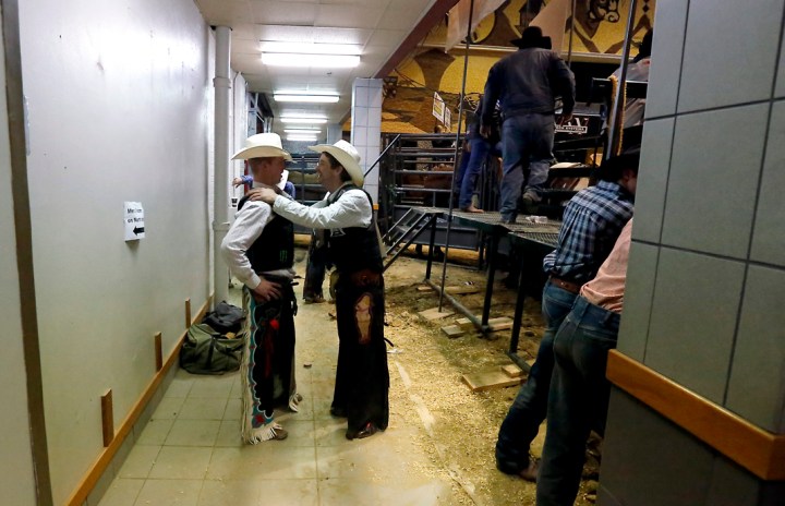 Dalton Dampler, of Belle Fouche, gets words of encouragement from Chris Newsom, of Hammon, Okla., prior to the championship round while competing in the bull riding as part of the Wilbur-Ellis Corn Palace Challenge on Saturday night at the corn palace in Mitchell. (Matt Gade/Republic)