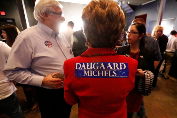 A Gov. Dennis Daugaard supporter shows her support with a bumper sticker on her back during the Republican Election Party on Tuesday night at The District restaurant in Sioux Falls. (Matt Gade/Republic)