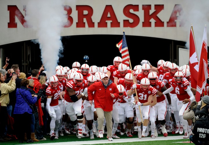 Nebraska Head Coach Bo Pelini and the rest of the Huskers run out onto the field prior to the start of the NU-Minnesota game on Saturday. (© Matt Gade)