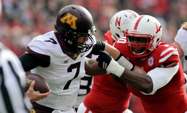 Nebraska Cornhuskers defensive end Greg McMullen (90) grabs Minnesota Golden Gophers quarterback Mitch Leidner (7) for tackle for loss during a game on Saturday at Memorial Stadium in Lincoln. (© Matt Gade)