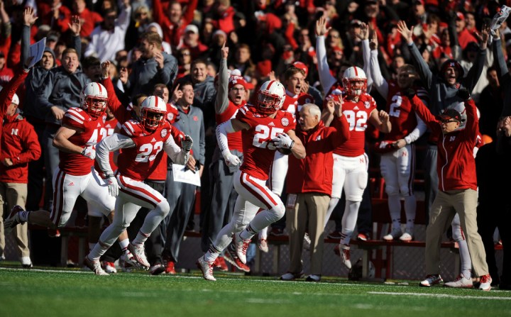 Nebraska Cornhuskers defensive back Nate Gerry (25) runs back a blocked field goal for a touchdown during a game on Saturday at Memorial Stadium in Lincoln. (© Matt Gade)