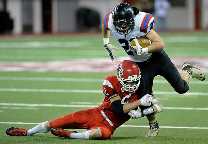 Woonsocket/Wessington Springs/Sanborn Central's Landon Ochsner (23) tries to escape the tackle of Gregory's Jayden VanDerWerff (3) during the 9AA state championship game on Thursday at the DakotaDome in Vermillion. (Matt Gade/Republic)