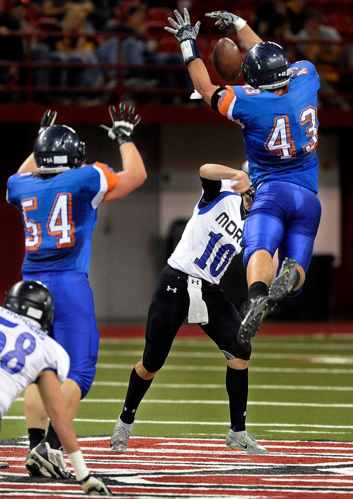 Parkston's Brady Reiff (43) gets air to block a pass by St. Thomas More's Matthew Eastmo (10) during the 11B state championship game on Friday at the DakotaDome in Vermillion. (Matt Gade/Republic)