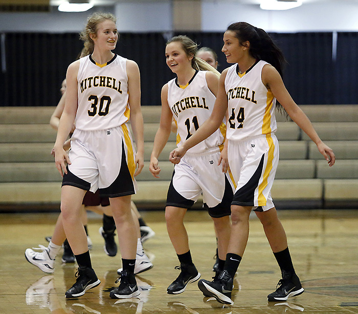 Mitchell's Ally Goldammer (30), Mitchell's Erin Farnham (11) and Mitchell's Taylor Volesky (24) celebrate their win over Harrisburg Tigers during a game Tuesday night at the Corn Palace. (Matt Gade/Republic)
