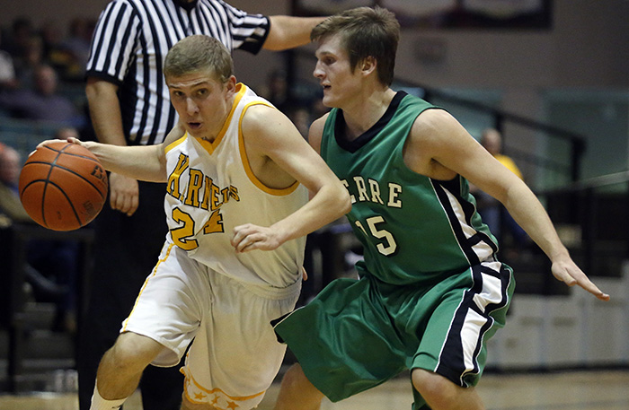 Mitchell High School's Beau Brown drives to the basket past a Pierre T. F. Riggs' defender during a game on Friday night at the Corn Palace in Mitchell. (Matt Gade/Republic)