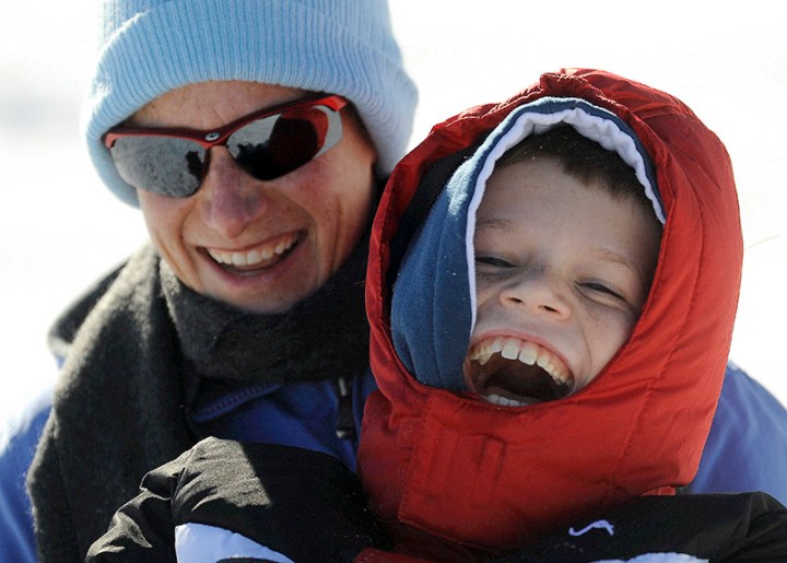 Eight-year-old Jonathan VanMeter has a blast riding down the hill with his mom, Denise, while sledding on a hill next to Lake Mitchell on Friday afternoon in Mitchell. (Matt Gade/Republic)
